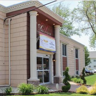 A building exterior with prominent columns and well-maintained landscaping.
