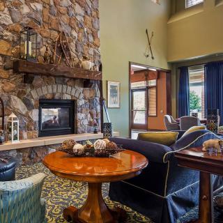 A cozy living room with a stone fireplace and stylish furniture.