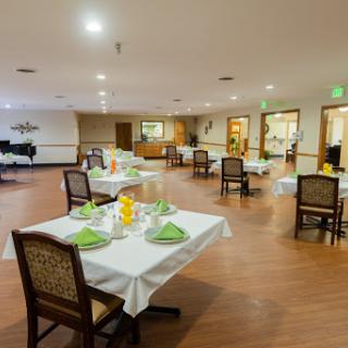 A spacious and inviting dining area with neatly set tables, ready for guests.