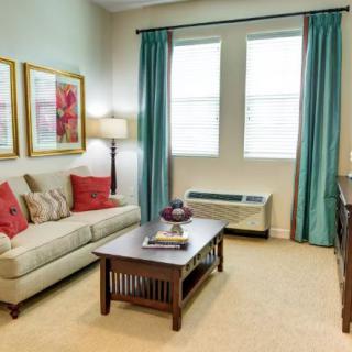 A cozy living room with a sofa, coffee table, and decorative artwork.