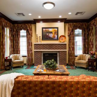 A cozy living room with a fireplace, adorned with elegant furniture and decorative elements.
