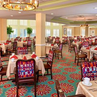 An elegantly decorated dining room with neatly arranged tables and chairs.