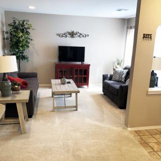 A modern living room featuring a cozy seating area, television, and elegant decor.