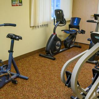A small indoor gym with several stationary bikes and exercise machines.