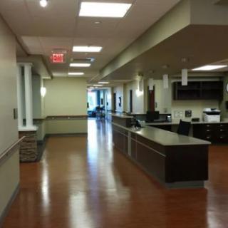 A modern hospital reception area with a hallway.