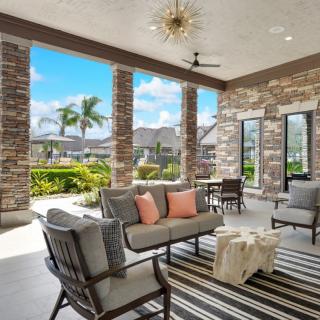 A stylish outdoor patio with comfortable seating and a scenic view.