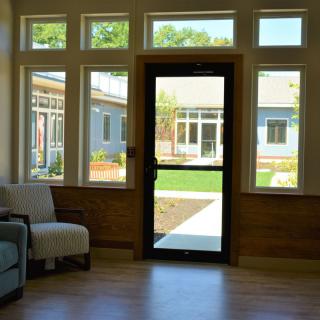 A cozy lobby area with large windows and a view of the outdoors.