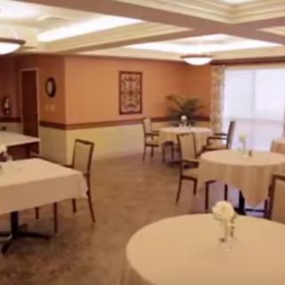 A neatly arranged dining area with tables and chairs, exuding a cozy ambiance.