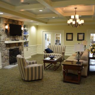A cozy and elegantly designed living room featuring a comfortable seating area and a charming fireplace.