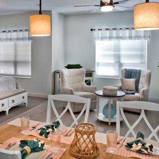 A cozy and stylish open-concept living and dining area with elegant decor and abundant natural light.