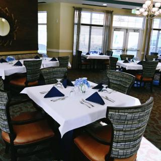 A neatly arranged restaurant dining area with tables set for guests.