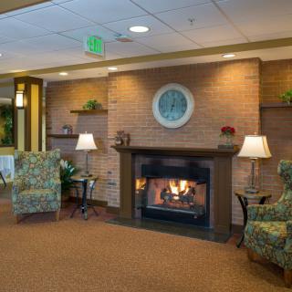A cozy lobby with a fireplace and comfortable seating arrangements.
