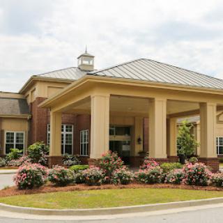 A well-designed community center featuring a welcoming entrance and beautiful landscaping.