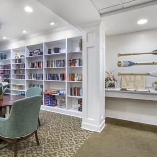A cozy library space with bookshelves and comfortable seating.