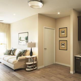 A modern living room featuring a comfortable sofa, stylish lamp, and framed artwork on the walls.