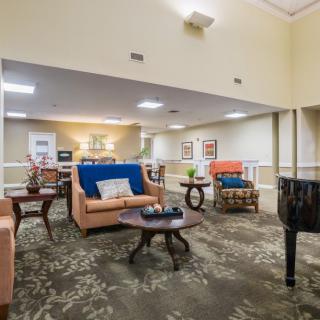 A cozy living room with sofas, tables, and decorative elements.