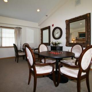 A cozy dining room with elegant furniture and decor.