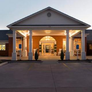 A well-lit building entrance in the evening.