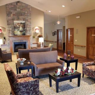 A cozy living room with comfortable seating and a fireplace.