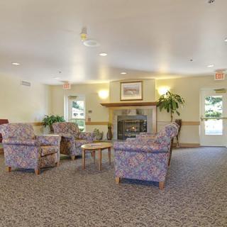 A cozy living room with comfortable seating and a fireplace.