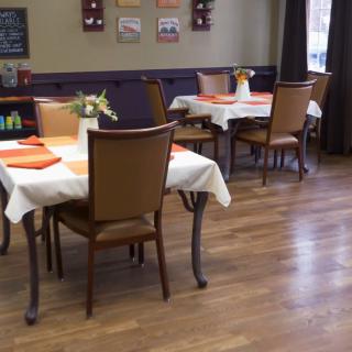 A cozy restaurant interior with neatly arranged tables and chairs.