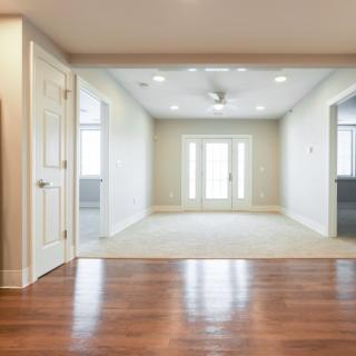 A bright and spacious living room with wooden flooring and a modern design.