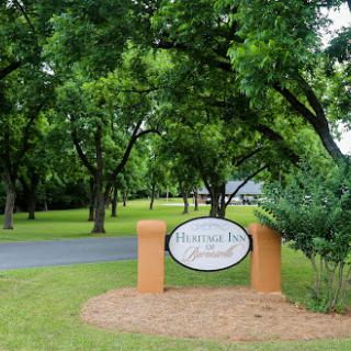 A welcoming sign surrounded by lush greenery, indicating the entrance to a community.