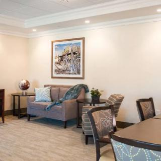 A well-decorated living room featuring a sofa, chairs, and a decorative table.