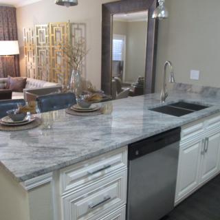 Modern kitchen with a marble countertop and open concept design.