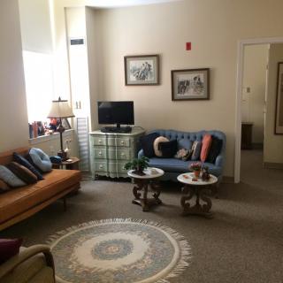 A cozy living room with sofas, a television, and decorative elements.