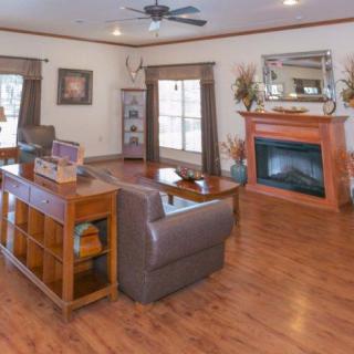 A cozy living room featuring a fireplace, hardwood floors, and comfortable seating.