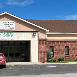 Exterior view of a medical facility with clear signage under a blue sky.