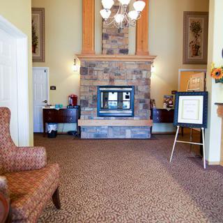 A cozy lobby featuring a stone fireplace and comfortable seating.