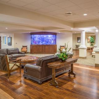 A spacious lobby with comfortable seating and a large aquarium display.