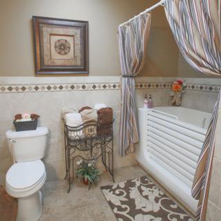 A cozy bathroom with a bathtub and decorative elements.