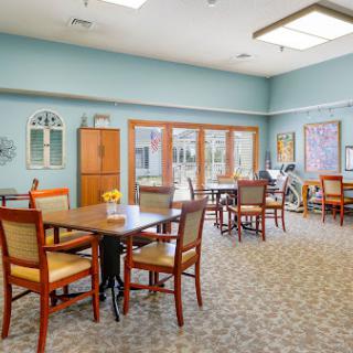 A well-lit and inviting dining area with tables and chairs, perfect for community gatherings.