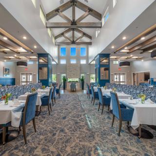 A spacious and elegantly designed banquet hall set up for a formal event.