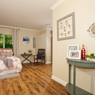 A cozy bedroom with wooden flooring and tasteful decor.