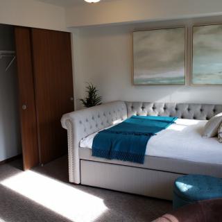 A cozy bedroom with a stylish bed and minimalist decor.