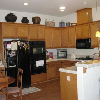 Spacious kitchen with wooden cabinets, modern appliances, and a small dining area.