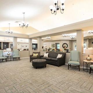 Spacious and elegantly furnished lobby area with seating and chandeliers.