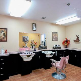 Interior of a barber shop with styling chairs, mirrors, and salon equipment.