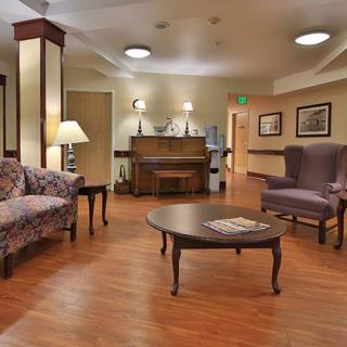 A warmly decorated lobby area with comfortable seating and a piano.