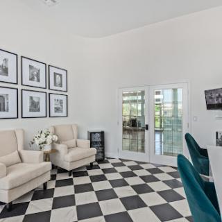 A stylish living room featuring contemporary furniture and a striking black and white checkered floor.