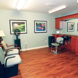 A cozy hair salon with a barber chair and waiting area.