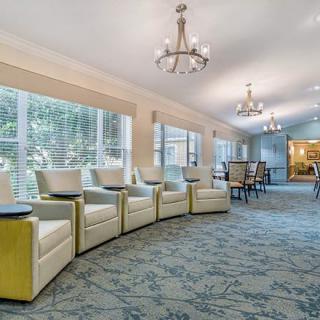 A spacious and elegantly decorated living room with comfortable seating and large windows.
