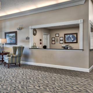 A well-appointed lobby featuring a reception desk and comfortable seating.