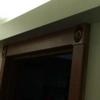 A wooden door frame with decorative elements.