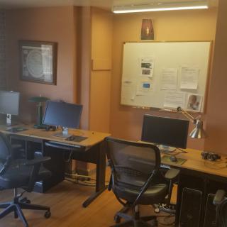 A well-organized office workspace with multiple desks and computers.