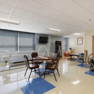 A spacious rehabilitation room equipped with exercise tools and a comfortable seating area.